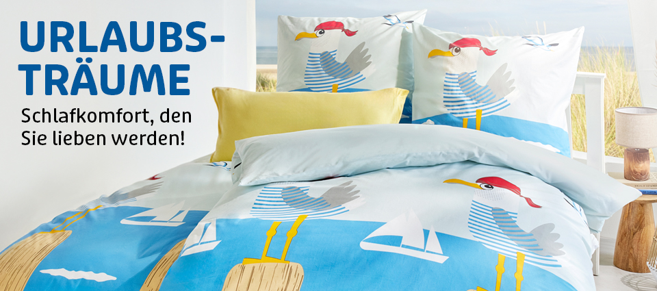 Bettwäsche mit Möwen-Design und maritimen Farben auf einem Bett