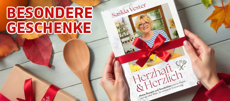 Buchgeschenk mit roter Schleife und Kochutensilien