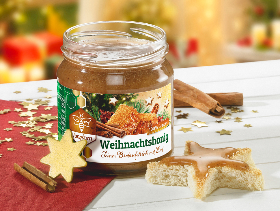 Glas Weihnachtshonig mit Zimt und weihnachtlicher Dekoration