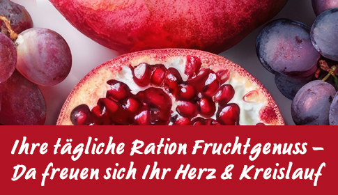 Aufgeschnittener Granatapfel und rote Trauben in Nahaufnahme.